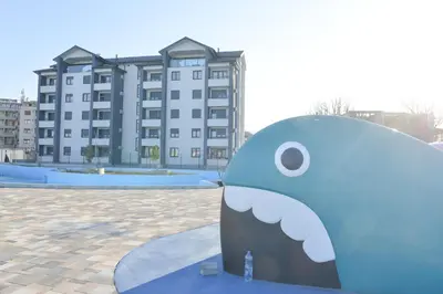 a blue dolphin statue in front of a building at Apartmani Martenovic in Vrnjačka Banja