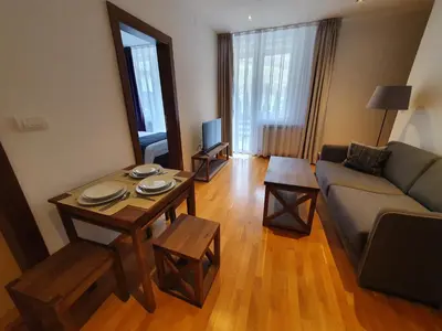 a living room with a couch and a table at PLANINSKO JUTRO - Brzeće Centar Apartments, Kopaonik in Brzeće