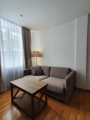a living room with a couch and a coffee table at PLANINSKO JUTRO - Brzeće Centar Apartments, Kopaonik in Brzeće