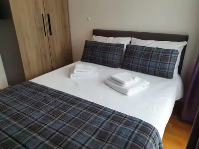 a bed with two towels and two pillows on it at PLANINSKO JUTRO - Brzeće Centar Apartments, Kopaonik in Brzeće