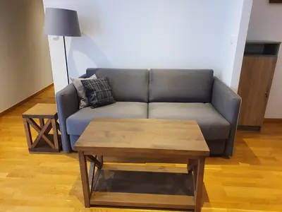 a living room with a couch and a coffee table at PLANINSKO JUTRO - Brzeće Centar Apartments, Kopaonik in Brzeće