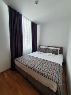 a bedroom with a large bed with a window at PLANINSKO JUTRO - Brzeće Centar Apartments, Kopaonik in Brzeće