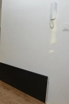 a white wall with a monitor in a room at Apartman Martenovic 2 in Vrnjačka Banja
