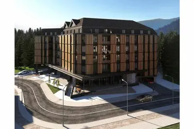 a large building with a skate park in front of it at Woodside Kopaonik Residences in Kopaonik
