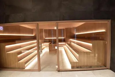 a wooden cabinet with glass doors in a room at Woodside Kopaonik Residences in Kopaonik