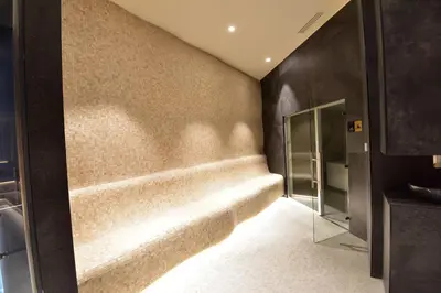 a bathroom with a bench in the corner of a room at Woodside Kopaonik Residences in Kopaonik