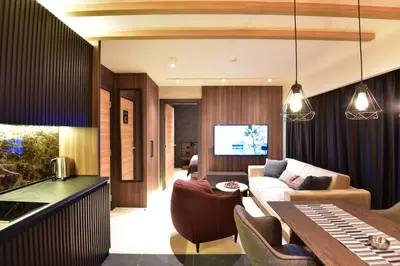 a living room with a couch and a table at Woodside Kopaonik Residences in Kopaonik