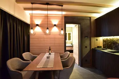a dining room with a wooden table and chairs at Woodside Kopaonik Residences in Kopaonik