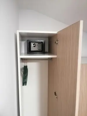 a microwave sitting on a shelf in a closet at Apartman MIA Centar in Kruševac