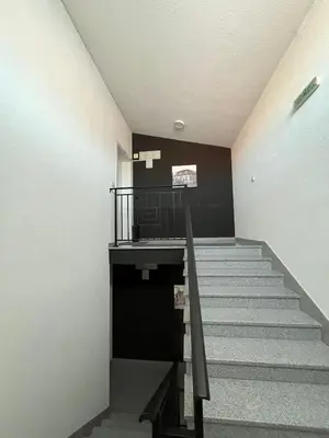 a staircase in a building with a stair case at Apartman MIA Centar in Kruševac