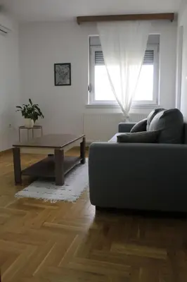 a living room with a couch and a coffee table at Apartman Bonaca in Vrnjačka Banja