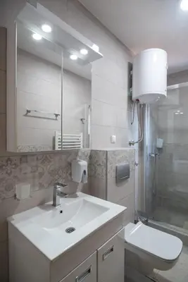 a bathroom with a sink and a toilet and a shower at Apartman Bonaca in Vrnjačka Banja