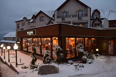 a store with snow on the ground in front of a building at NATURA LUX MILMARI k 12 in Kopaonik