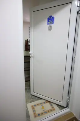 a refrigerator with a sign on the door at Apartmani Đorđević in Soko Banja
