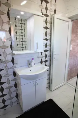 a bathroom with a white sink and a mirror at Apartmani Đorđević in Soko Banja