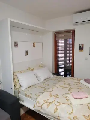 a bedroom with a large bed in a room at Apartman Lala in Vrnjačka Banja