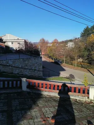 a brick wall with a road in the background at Apartman Lala in Vrnjačka Banja