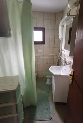 a bathroom with a sink and a toilet and a shower at Apartmani Trio in Soko Banja