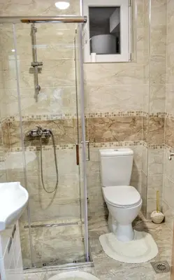 a bathroom with a toilet and a shower at Apartman Krila andjela in Vrnjačka Banja
