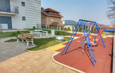 a playground with a swing set and a bench at Apartman Krila andjela in Vrnjačka Banja