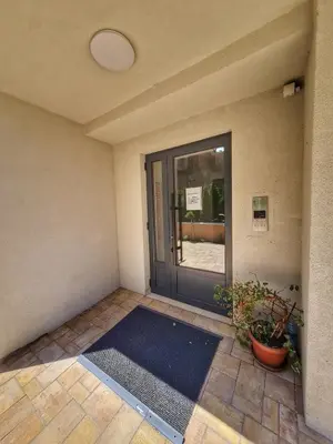 an empty room with a glass door with a plant at Apartman Krila andjela in Vrnjačka Banja