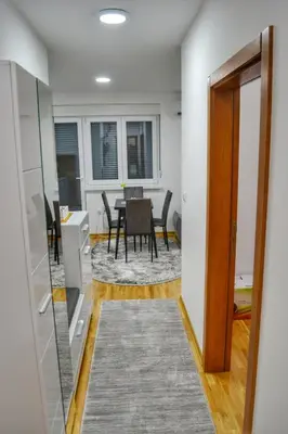 a dining room with a table and chairs in a room at Apartman Krila andjela in Vrnjačka Banja