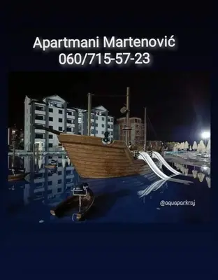 a boat sitting on top of a harbor at night at Apartmani Martenovic 1 in Vrnjačka Banja
