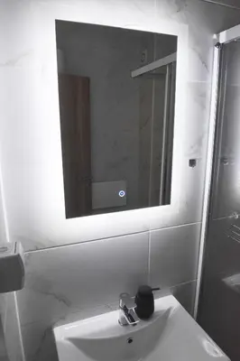 a bathroom with a sink and a mirror at Apartmani Martenovic 1 in Vrnjačka Banja