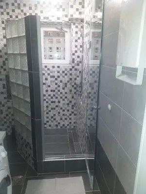 a shower with a glass door in a bathroom at Aurora in Kruševac