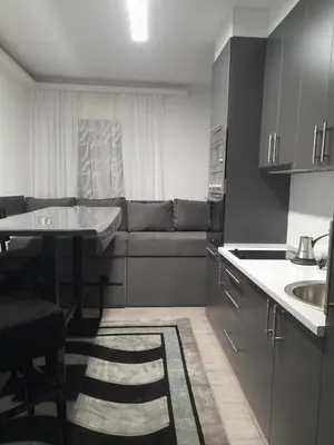 a kitchen with a couch and a table in it at Aurora in Kruševac