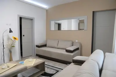 a living room with a couch and a table at Aurora in Kruševac
