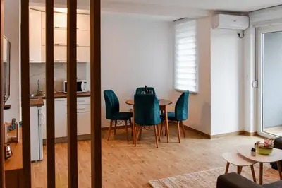 a kitchen and dining room with a table and chairs at Vuković Lux in Vrnjačka Banja