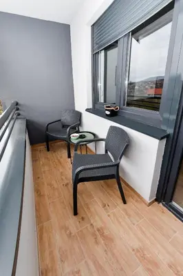 a room with two chairs and a table and a window at Vuković Lux in Vrnjačka Banja