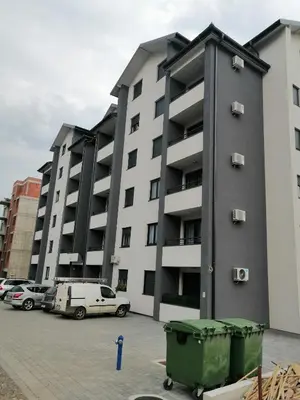 a large building with cars parked in a parking lot at Vuković Lux in Vrnjačka Banja