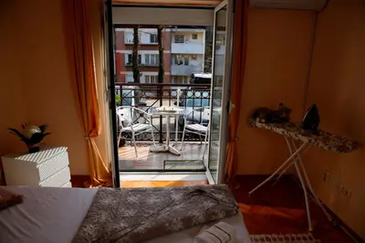 a room with a door open to a balcony with a table at Apartman Dunja in Vrnjačka Banja