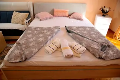 a large bed with two pillows on it at Apartman Dunja in Vrnjačka Banja