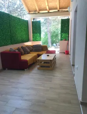 a living room with a couch and a table at Velin raj in Soko Banja