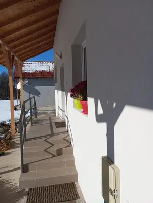 a shadow of a building on the side of a building at Apartmani Petrović SEMČE Suva Planina in Gadžin Han