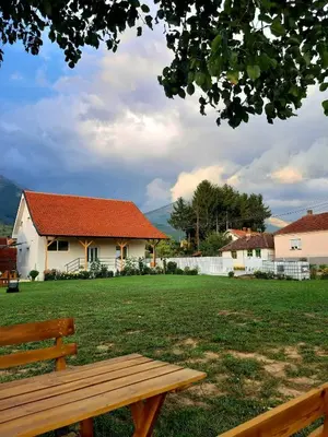 a wooden bench in front of a house at Apartmani Petrović SEMČE Suva Planina in Gadžin Han