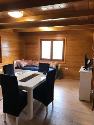 a room with a table and chairs and a couch at Etno selo Rasinski Lug in Ravni