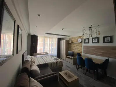 a living room with a couch and a bed at Milmari Premier 28 Kopaonik in Kopaonik