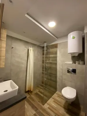 a bathroom with a toilet and a sink and a shower at Milmari Premier 28 Kopaonik in Kopaonik