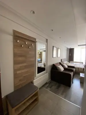 a living room with a couch and a large window at Milmari Premier 28 Kopaonik in Kopaonik