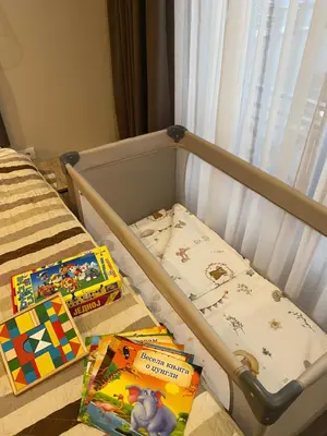 a crib with two childrens books on it at Milmari Premier 28 Kopaonik in Kopaonik