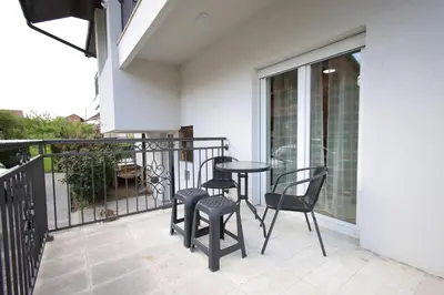 a balcony with chairs and a table on a balcony at Vila Vrnjački Raj in Vrnjačka Banja