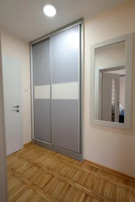 a glass door in a room with a mirror at Vila Vrnjački Raj in Vrnjačka Banja