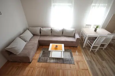 a living room with a couch and a table at Vila Vrnjački Raj in Vrnjačka Banja
