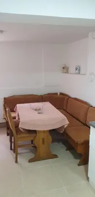 a living room with a table and a couch at Apartman Djekovic in Jošanička Banja