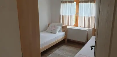 a small room with a bed and a window at Apartman Djekovic in Jošanička Banja