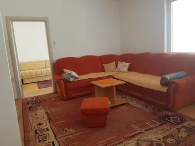 a living room with a brown couch and a table at Kragić apartman in Soko Banja